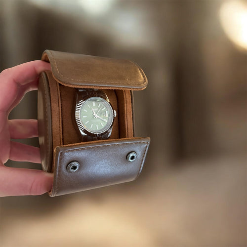TimelessPieces by Marcel brown leather 1-slot watch roll with soft interior, holding a silver watch.