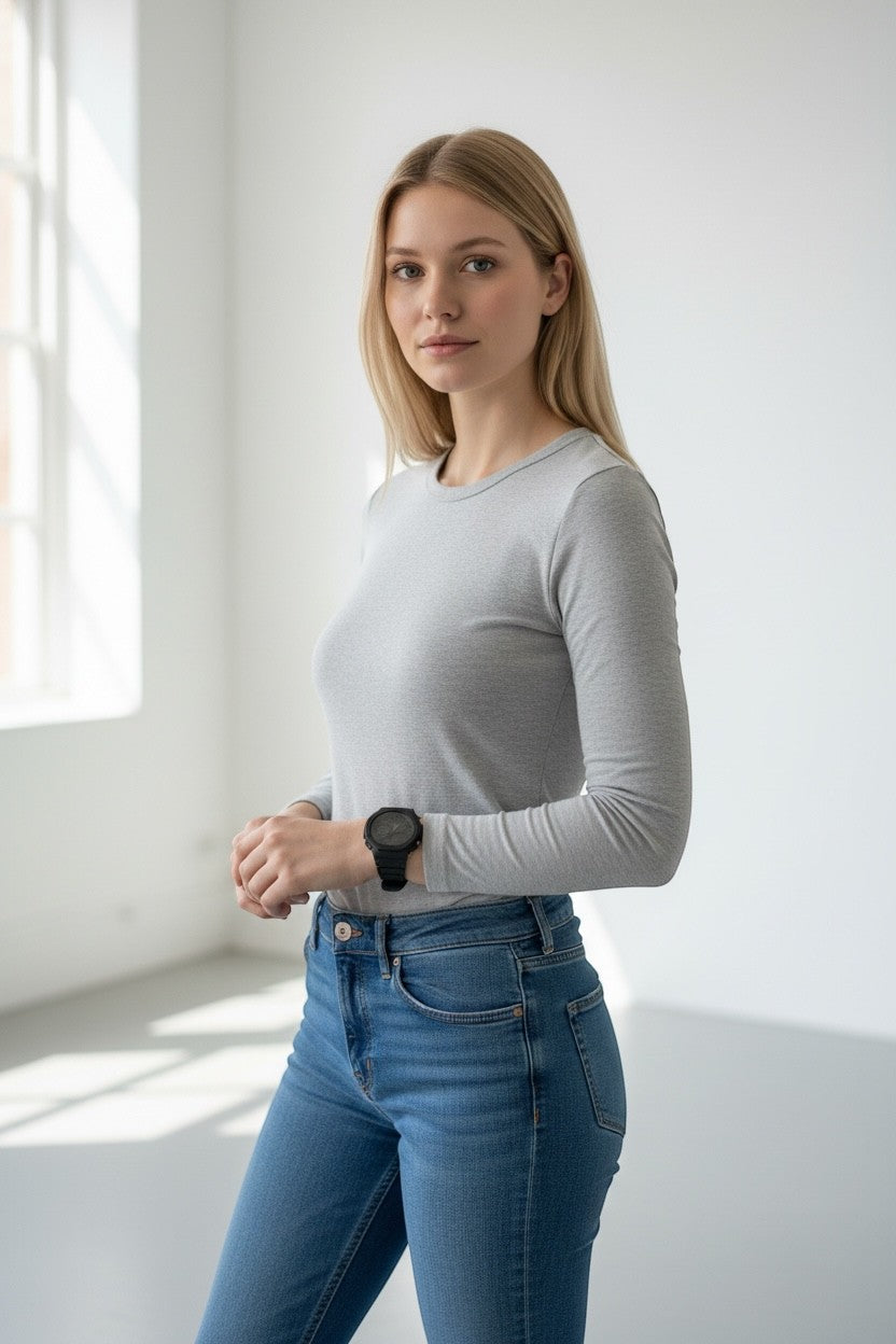 TimelessPieces by Marcel: Used black Casio G-Shock GA-2100 watch on a woman's wrist, paired with a grey long-sleeve shirt and blue jeans.