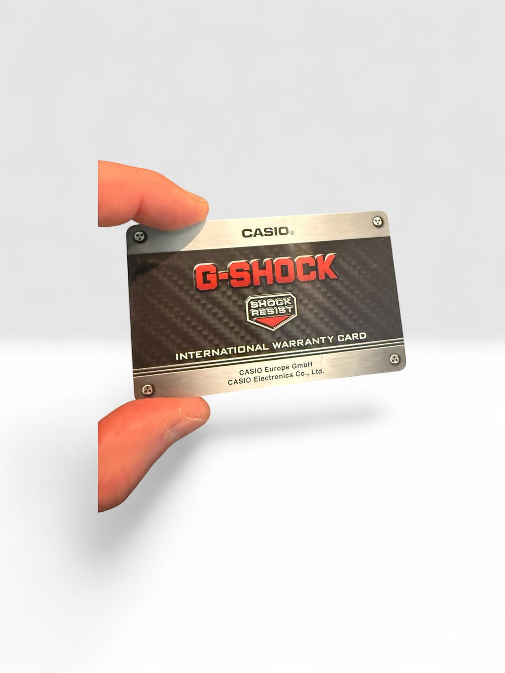 TimelessPieces by Marcel Casio G-Shock international warranty card with carbon fiber design. Shock Resist feature.